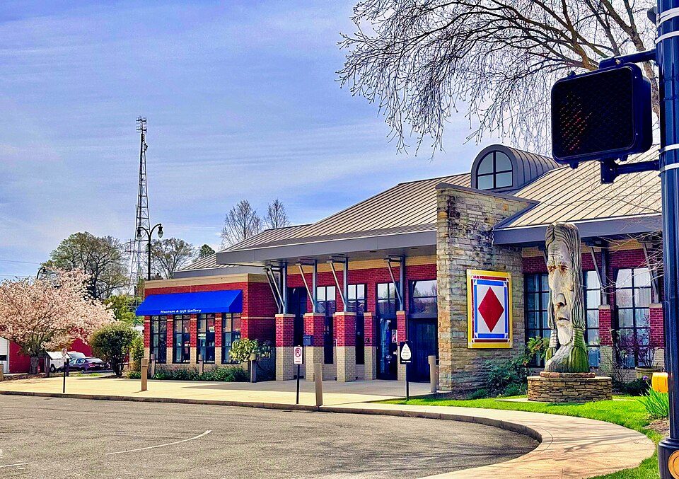 The Museum Center at 5ive Points in downtown Cleveland, Tennessee, with a carved wooden figure beside the entrance