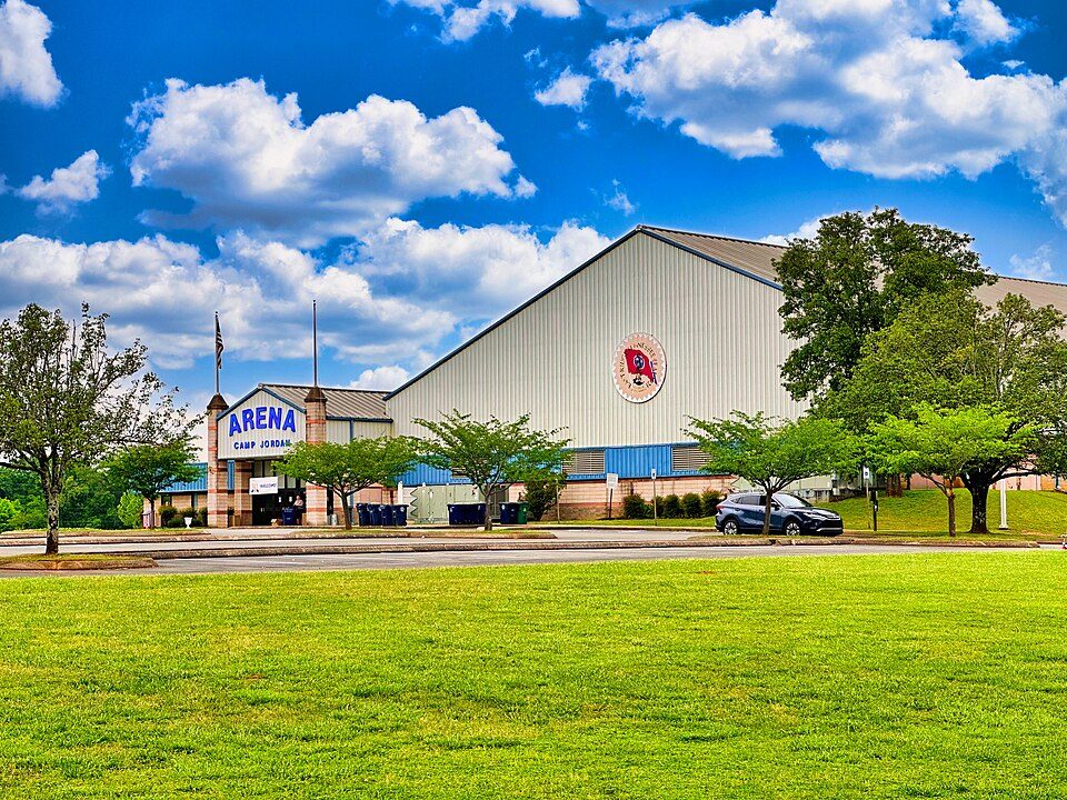 Camp Jordan Arena in East Ridge, Tennessee, a large metal-sided arena under a blue sky with white clouds