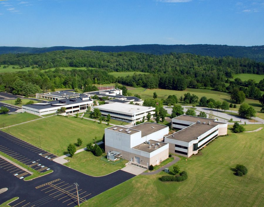 Aerial view of the Roane State Community College main campus in Harriman, Tennessee, surrounded by wooded hills