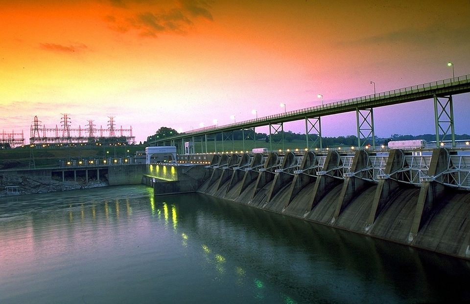 Fort Loudoun Dam on the Tennessee River at sunset, with lights along the dam
