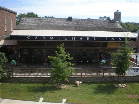 The Carmichael Inn, a long low building with a deck, in downtown Loudon, Tennessee