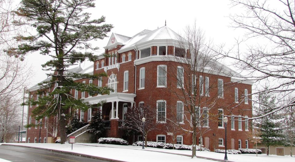 Bartlett Hall, a red-brick Victorian building at Maryville College, with snow on the ground
