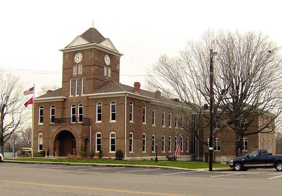 The brick Meigs County Courthouse in Decatur, Tennessee, with clock faces on its tower