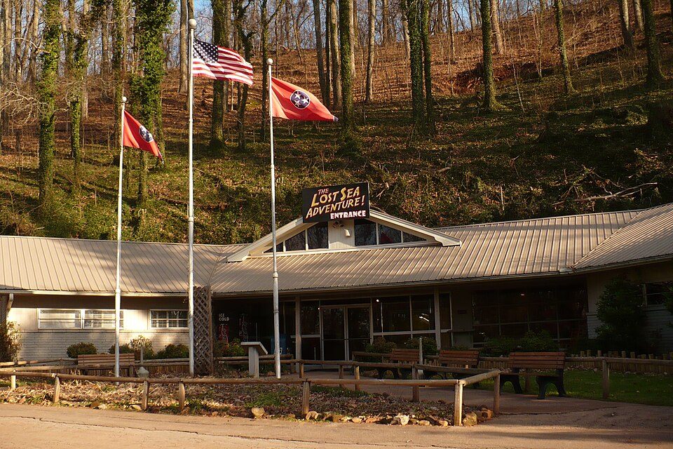The entrance building of the Lost Sea Adventure in Sweetwater, Tennessee, with flags out front